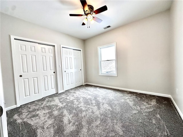 211 Ruby Dr, Menallen Twp, PA 15401 - unfurnished bedroom with carpet flooring, multiple closets, visible vents, and baseboards