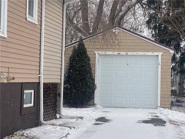 snow covered garage with a garage