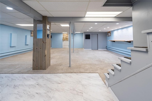 finished basement with recessed lighting, a baseboard radiator, a drop ceiling, and light colored carpet