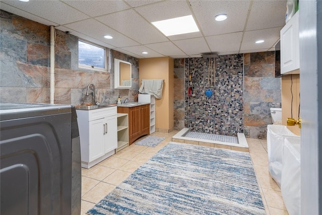 interior space featuring washer / clothes dryer, recessed lighting, a sink, and tile patterned floors