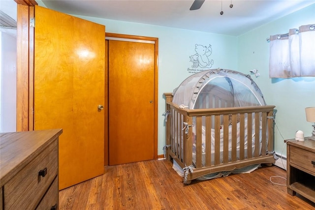 bedroom with a closet, ceiling fan, and wood finished floors