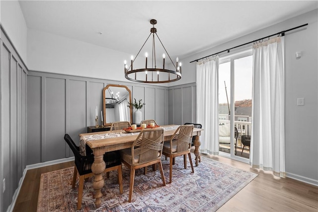 dining room with light wood-style flooring and a decorative wall