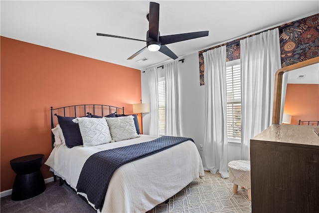 bedroom featuring light carpet, ceiling fan, visible vents, and baseboards