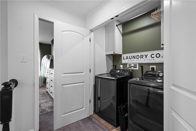 laundry room with washer and dryer, cabinet space, and carpet flooring