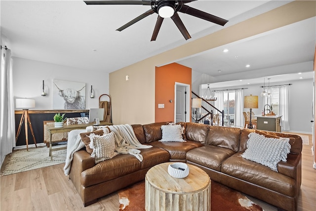 living area with stairway, light wood-type flooring, a ceiling fan, and recessed lighting