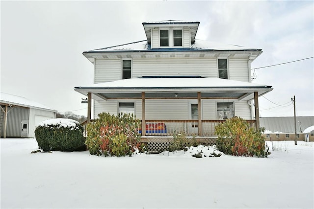 american foursquare style home featuring covered porch