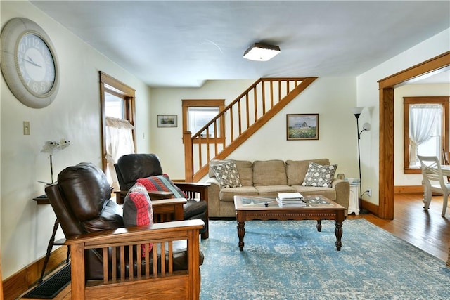 living area with baseboards, visible vents, a wealth of natural light, and wood finished floors