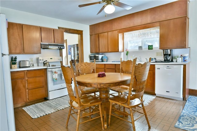 kitchen with ceiling fan, under cabinet range hood, white appliances, light countertops, and brown cabinets