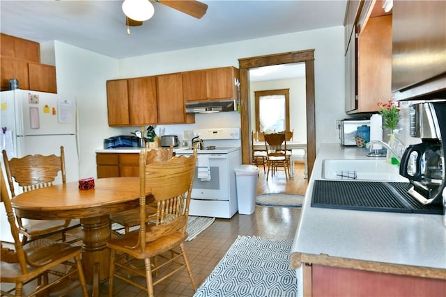 kitchen featuring under cabinet range hood, white appliances, a ceiling fan, light countertops, and brown cabinets