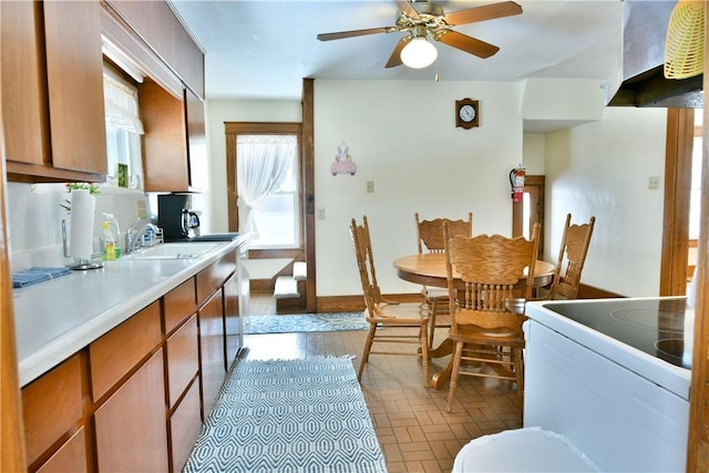 dining space with ceiling fan and baseboards