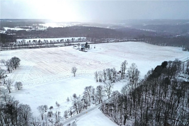 snowy aerial view featuring a rural view