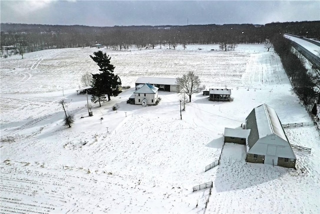 snowy aerial view featuring a rural view