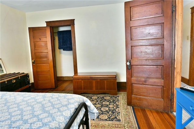 bedroom featuring baseboards and wood finished floors