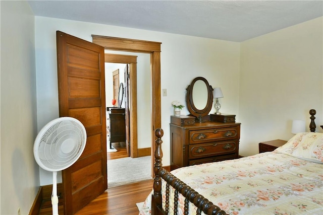 bedroom with baseboards and dark wood finished floors