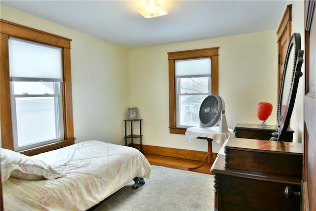 bedroom featuring wood finished floors and baseboards