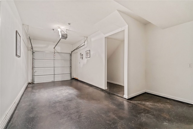 garage with baseboards and a garage door opener