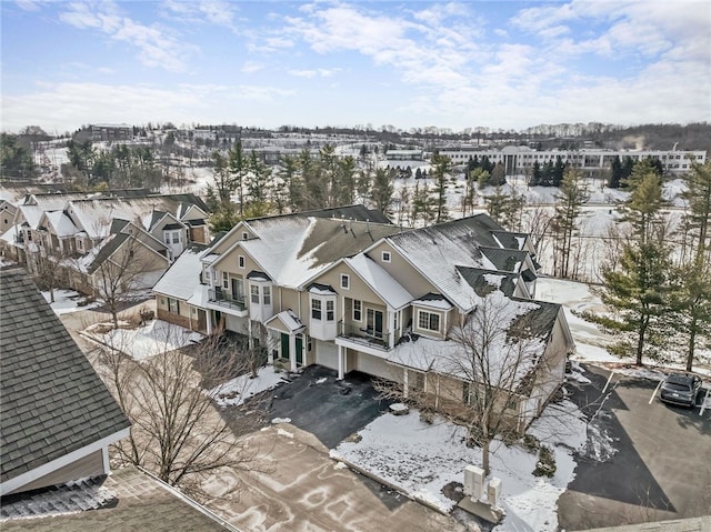 snowy aerial view with a residential view