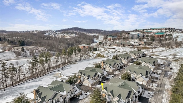 snowy aerial view with a residential view