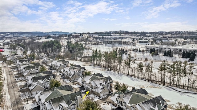 snowy aerial view with a residential view