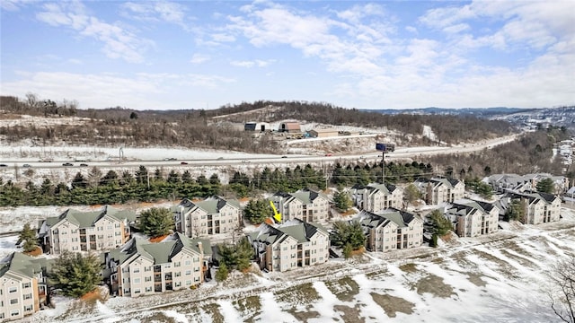 snowy aerial view with a residential view