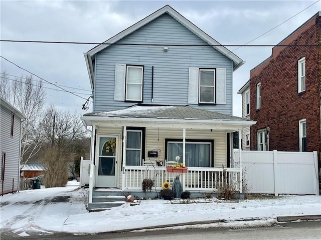 view of front of house with fence and a porch