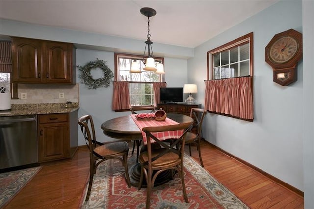 dining room with baseboards and wood finished floors