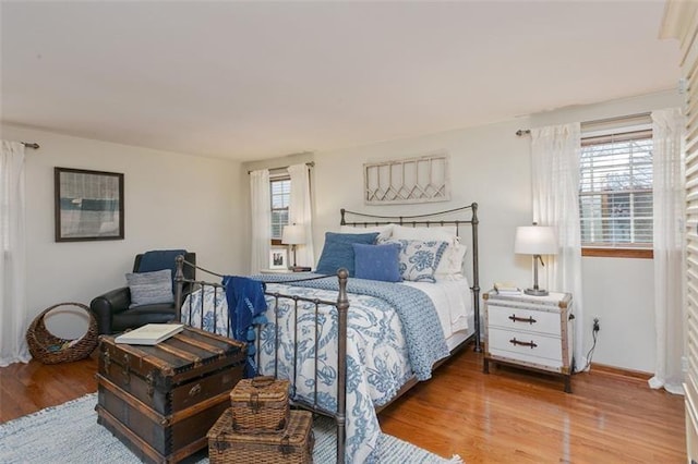 bedroom featuring wood finished floors and baseboards