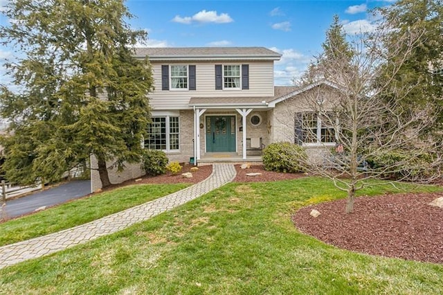 traditional-style home with a front lawn