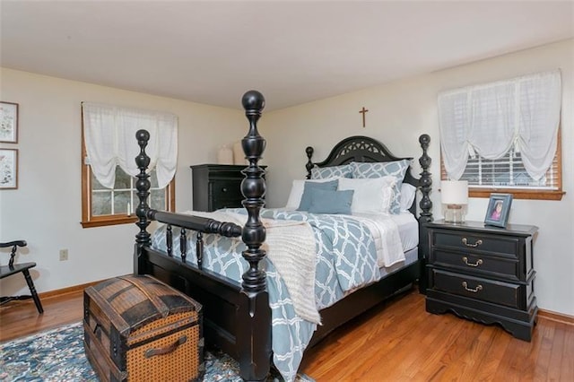 bedroom with wood finished floors and baseboards