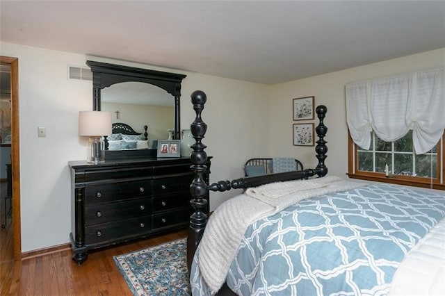 bedroom featuring dark wood-type flooring and visible vents