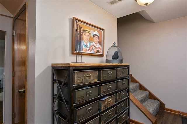 interior space with visible vents, baseboards, and wood finished floors