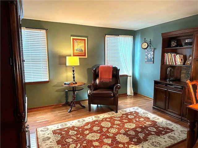 sitting room with light wood-type flooring and baseboards