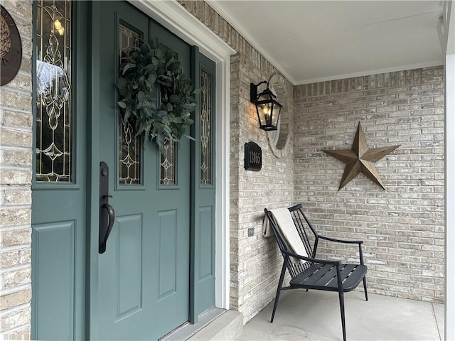 property entrance with brick siding