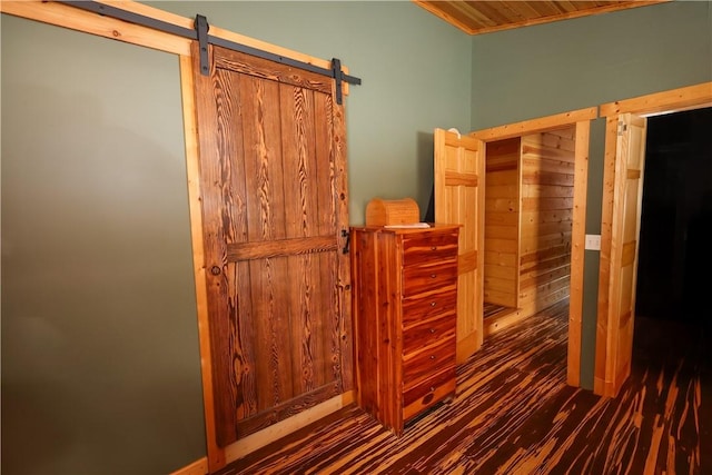 interior space featuring dark wood-style floors and a barn door