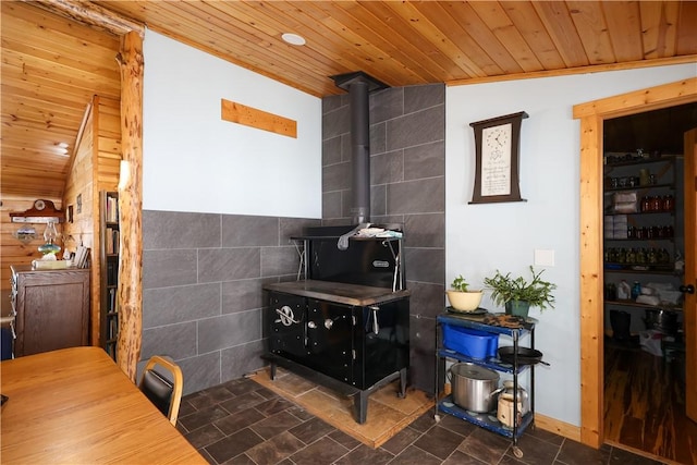 interior space featuring wooden ceiling and a wood stove