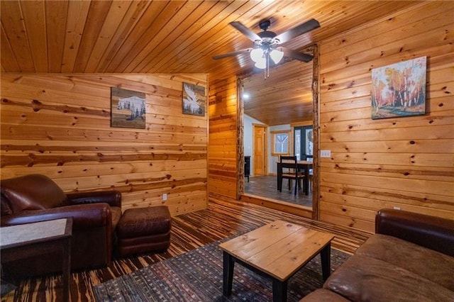 living room with lofted ceiling, ceiling fan, wood walls, and wooden ceiling