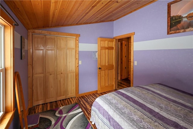 bedroom featuring dark wood-type flooring, wood ceiling, baseboards, vaulted ceiling, and a closet