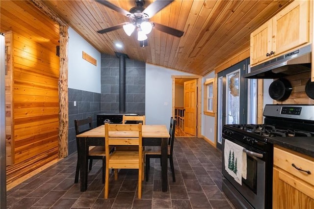 interior space featuring dark countertops, wood ceiling, light brown cabinets, gas range, and under cabinet range hood