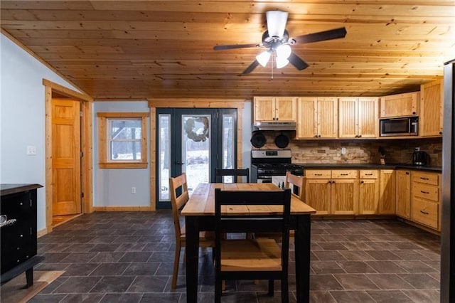 kitchen with dark countertops, light brown cabinetry, wood ceiling, stainless steel gas range, and built in microwave