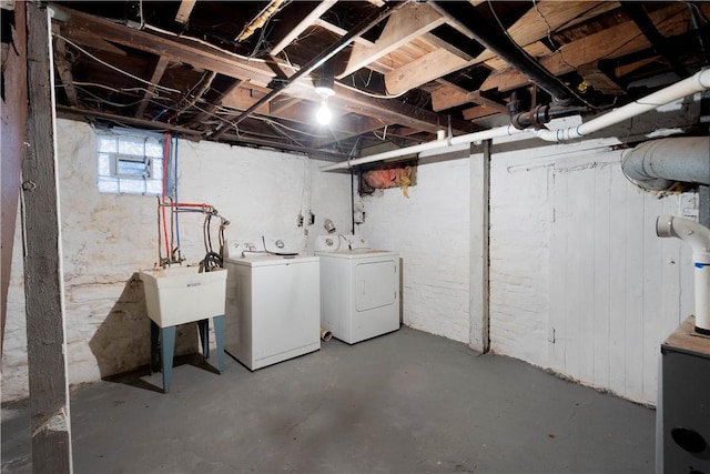 below grade area with washing machine and dryer and a sink