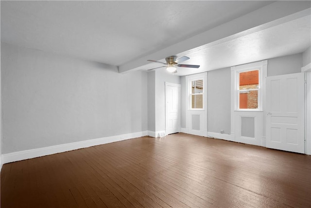 empty room featuring ceiling fan, dark wood finished floors, and baseboards