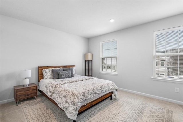 carpeted bedroom featuring baseboards