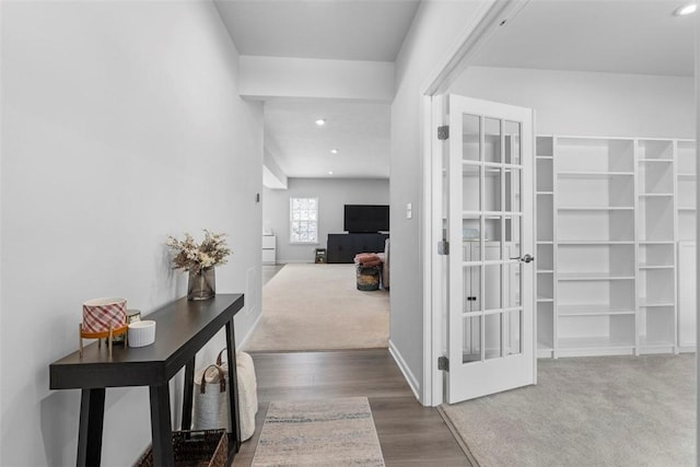 hallway featuring french doors, recessed lighting, carpet flooring, wood finished floors, and baseboards