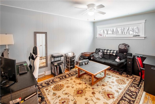 living room featuring ceiling fan and wood finished floors