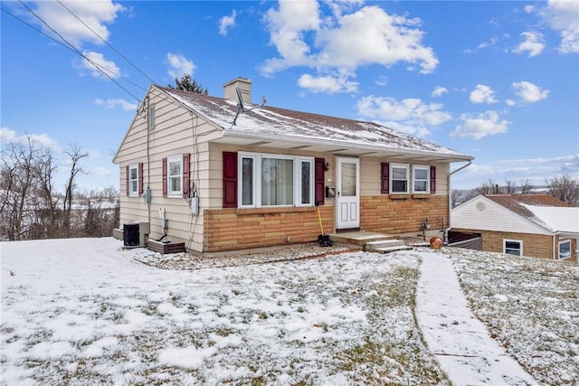 bungalow featuring a chimney