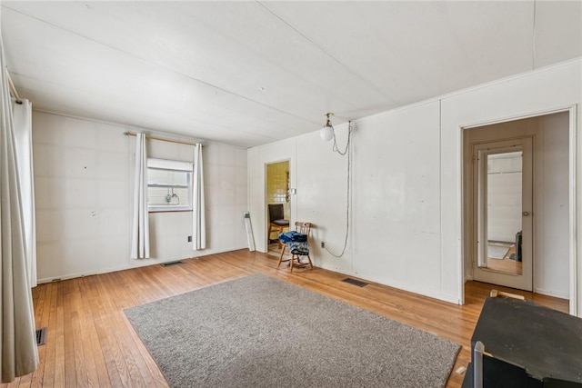 interior space featuring wood finished floors and visible vents