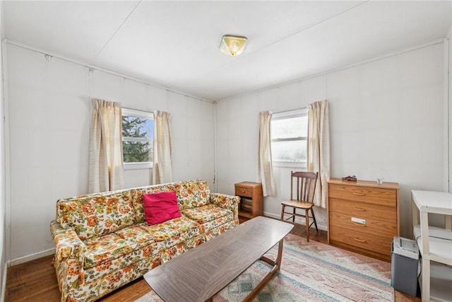 living room with plenty of natural light, wood finished floors, and baseboards