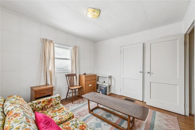 interior space with wood finished floors and visible vents