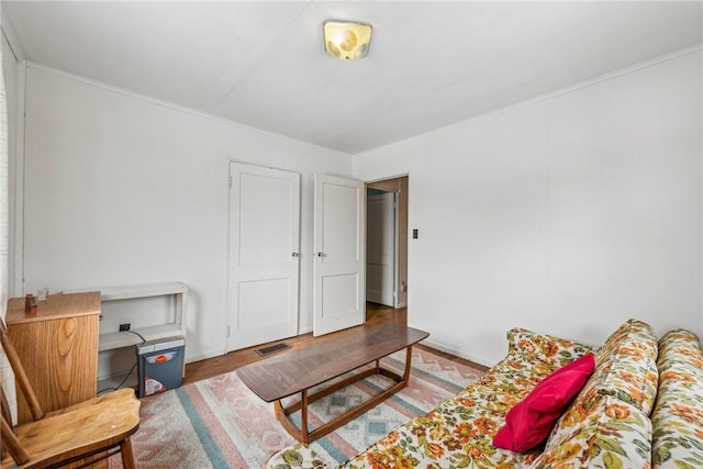 living room featuring visible vents and wood finished floors