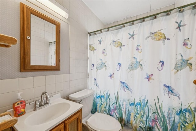 full bathroom with wallpapered walls, a shower with curtain, tile walls, and vanity